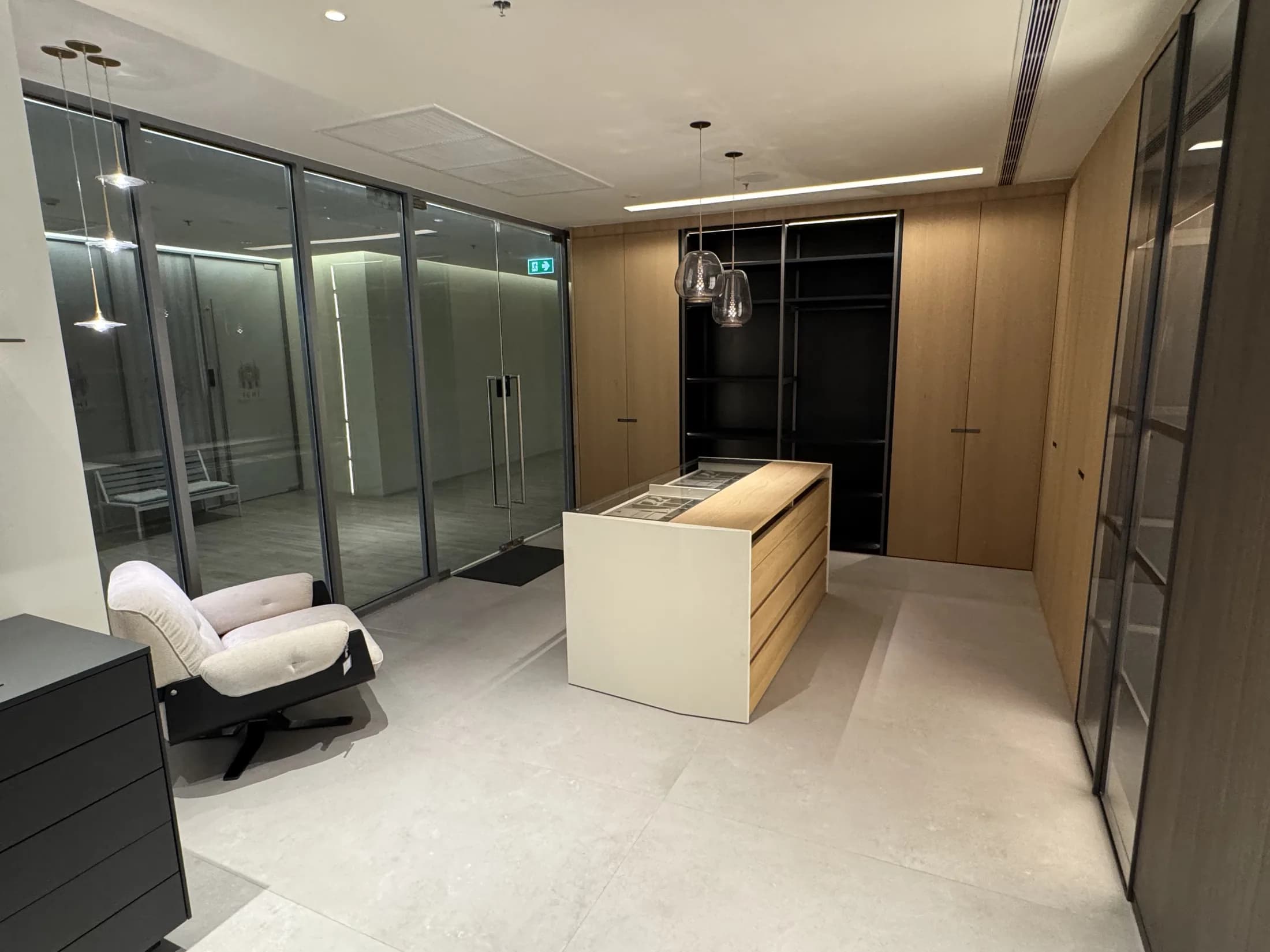 Bespoke oak walk-in dressing room with a custom island and integrated lighting